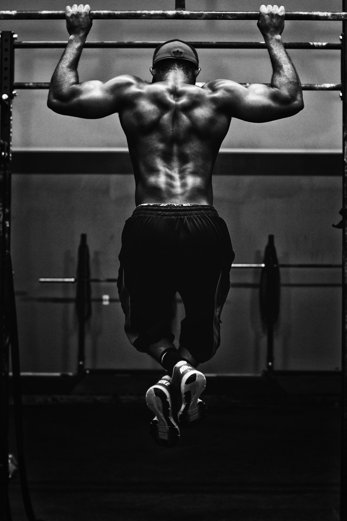 Athlete doing strict pull-ups, black and white