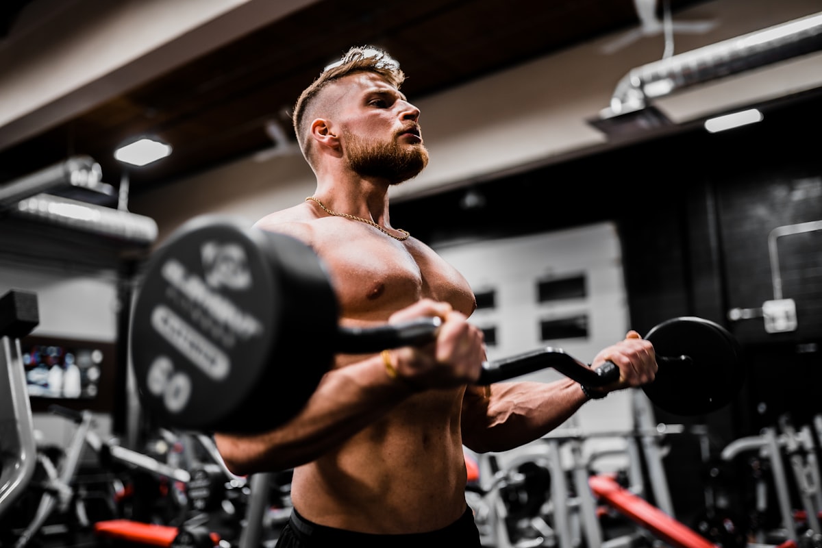 Athlete driving a prowler sled across the gym floor